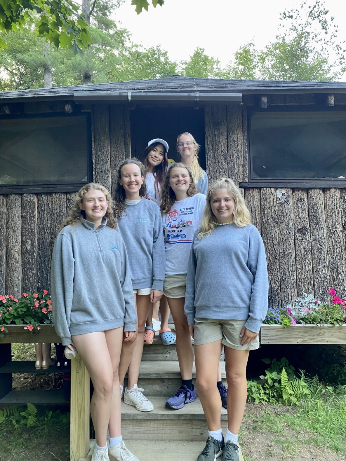Camp Connect USA - A group of people stood on the steps outside the cabin.