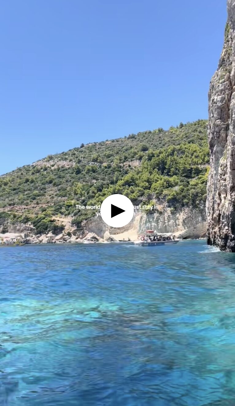 Camp Connect USA - Scenic coastal view with turquoise water, rocky cliffs, and a small cave opening.