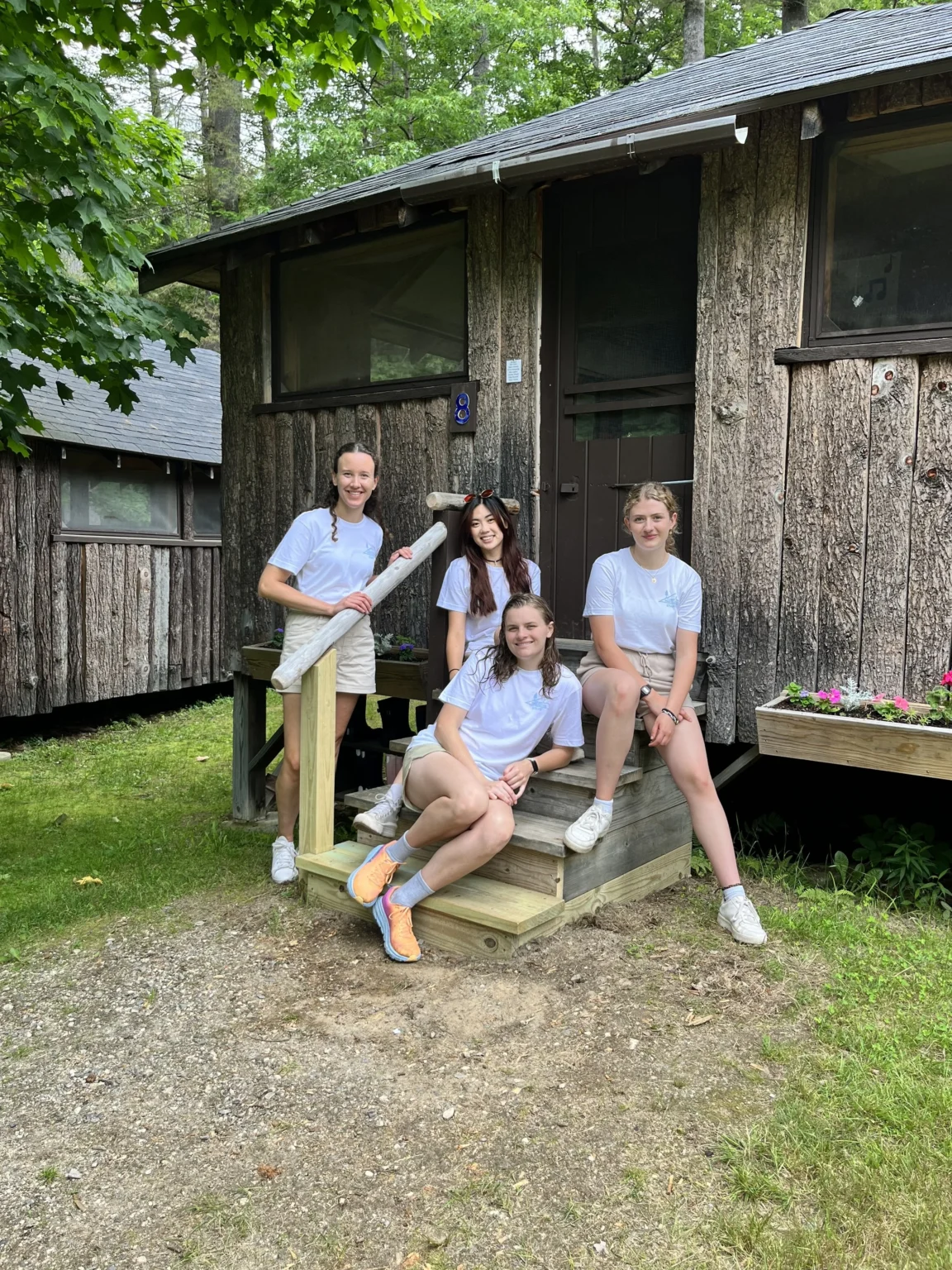camp-girls-outside-cabin-1152x1536