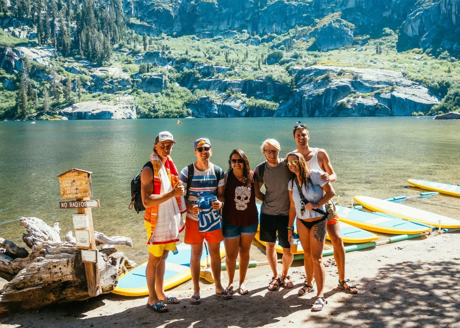 Camp Connect USA - Five people in front of a lake, surrounded by mountains.