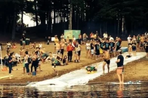 Camp Connect USA - A group of people in a river playing in the lake, some wearing life jackets.